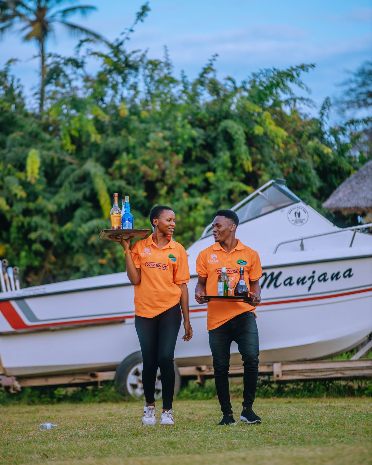 Ununio Beach Park crew walking past the boat Manjana with drinks trays